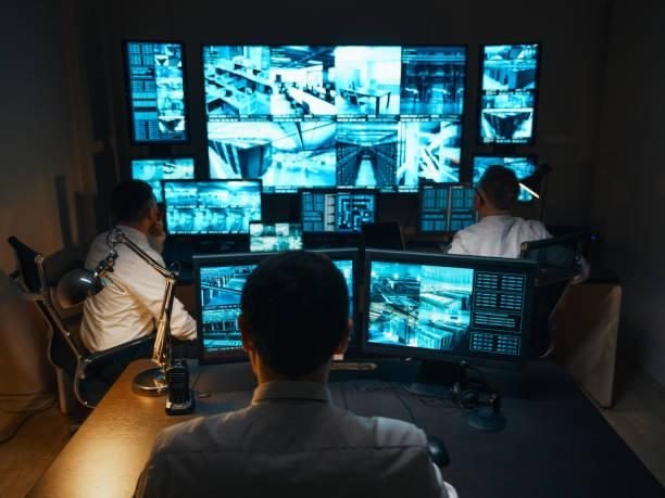 Monitoring team watching live CCTV screens in a control room