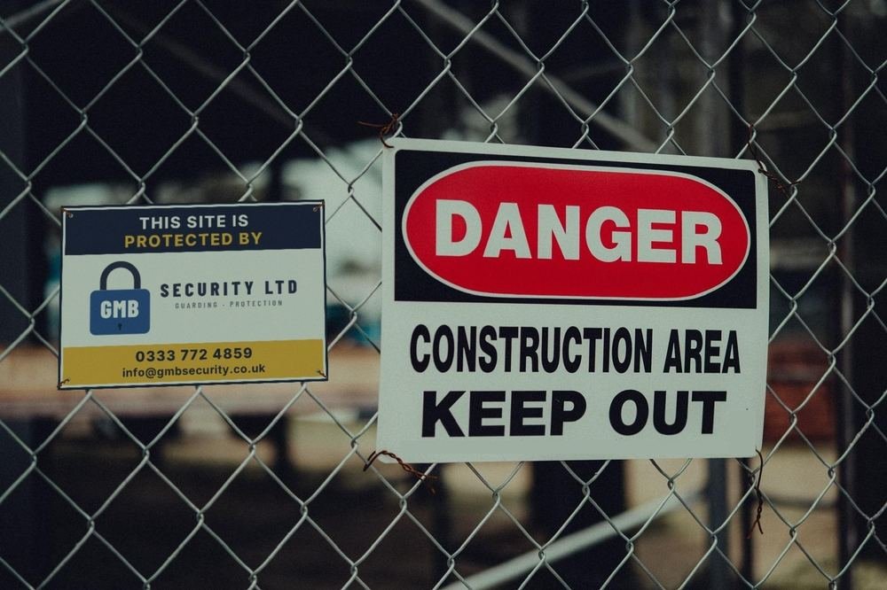 GMB Security site protection sign on a construction site fence
